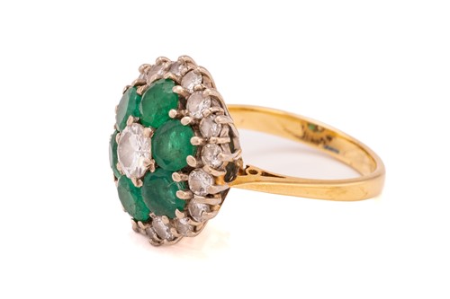 Lot 14 - An emerald and diamond cluster ring, centred...