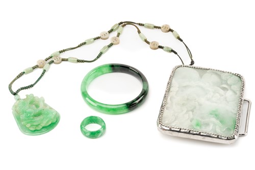 Lot 258 - A carved jadeite pendant and bangle, together...