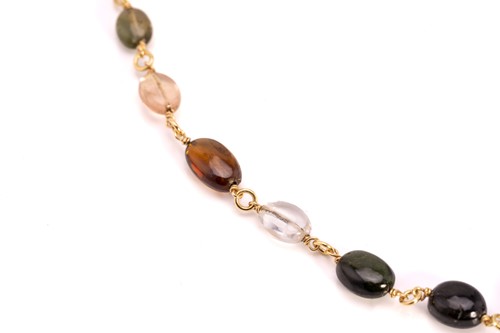 Lot 57 - A multi-gem bead necklace in 18ct yellow gold,...