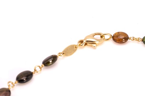 Lot 57 - A multi-gem bead necklace in 18ct yellow gold,...