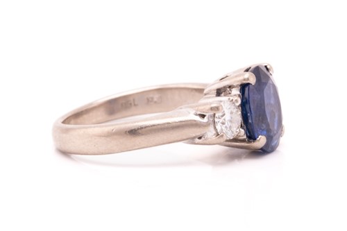 Lot 177 - A three-stone sapphire and diamond ring in...