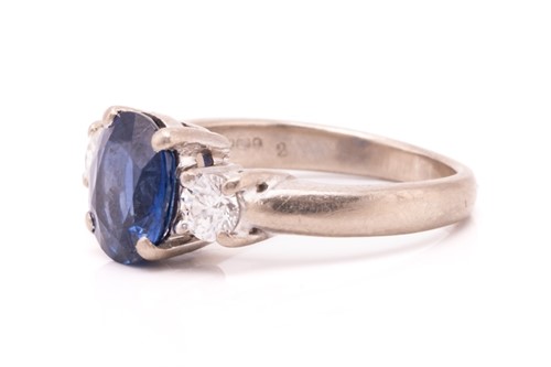 Lot 177 - A three-stone sapphire and diamond ring in...