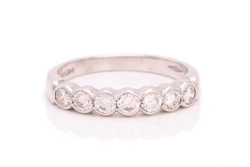 Lot 142 - A seven-stone diamond half-eternity ring in...