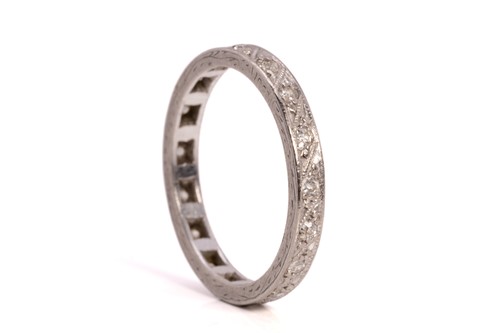 Lot 214 - A diamond eternity ring and a topaz trilogy...