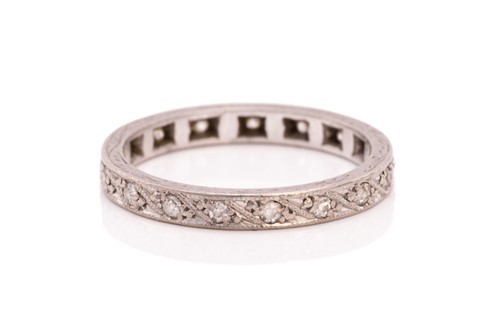 Lot 214 - A diamond eternity ring and a topaz trilogy...