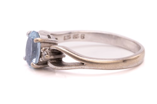 Lot 214 - A diamond eternity ring and a topaz trilogy...