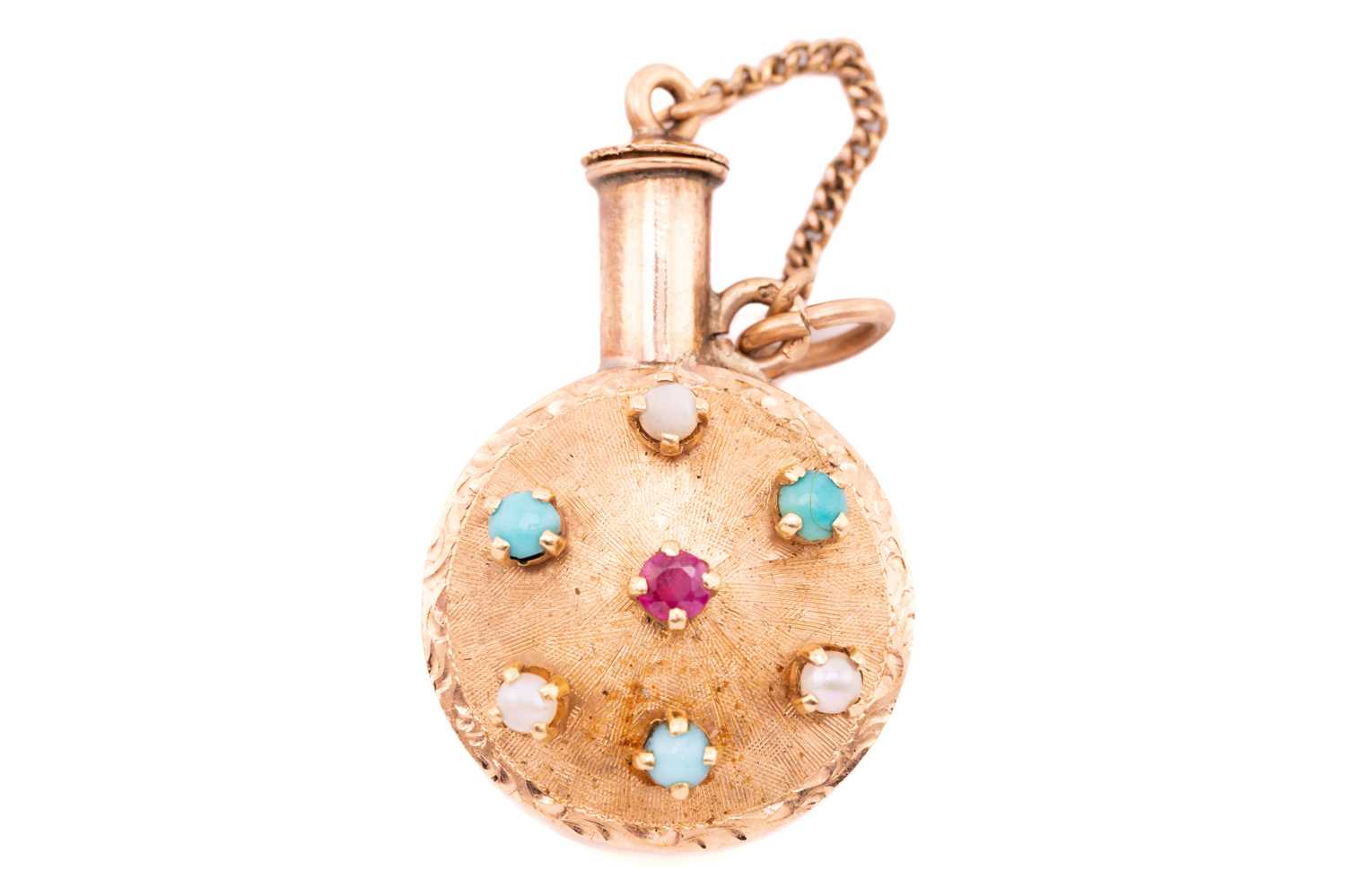 Lot 58 - A gem-set perfume bottle charm, one side of...