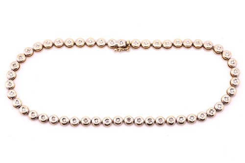 Lot 135 - A diamond set tennis bracelet, the round...