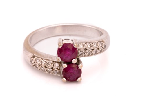 Lot 250 - A ruby and diamond crossover ring, featuring...