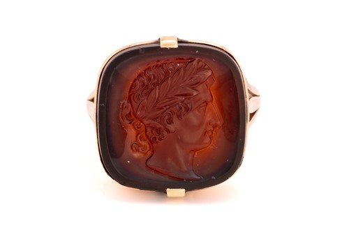 Lot 113 - A carnelian cameo ring, the square...