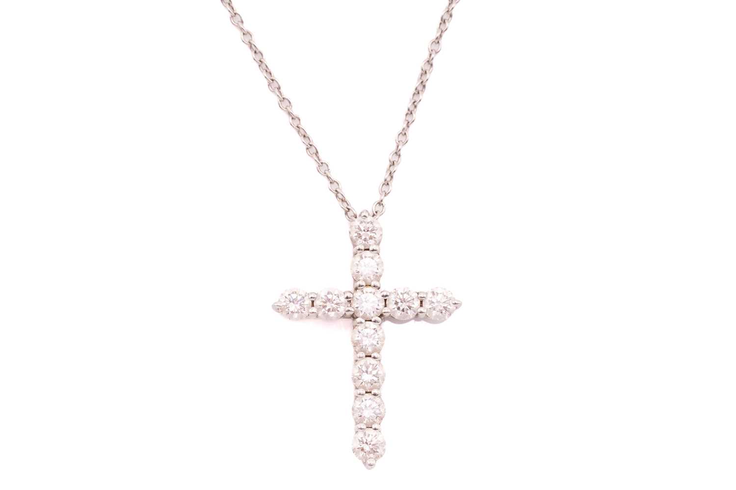 Lot 118 - Tiffany & Co. - a diamond cross pendant on...