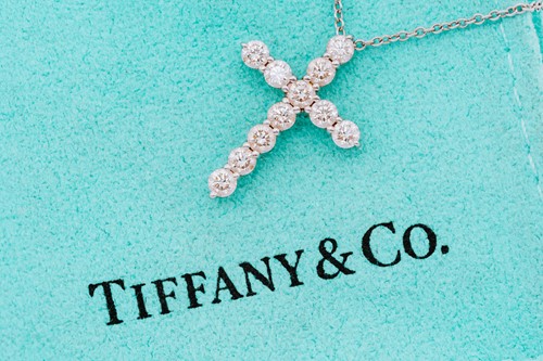 Lot 118 - Tiffany & Co. - a diamond cross pendant on...