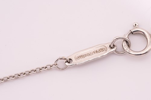 Lot 118 - Tiffany & Co. - a diamond cross pendant on...