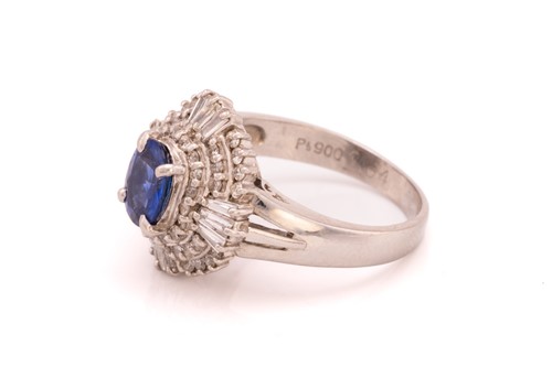 Lot 39 - A sapphire and diamond cluster ring, featuring...
