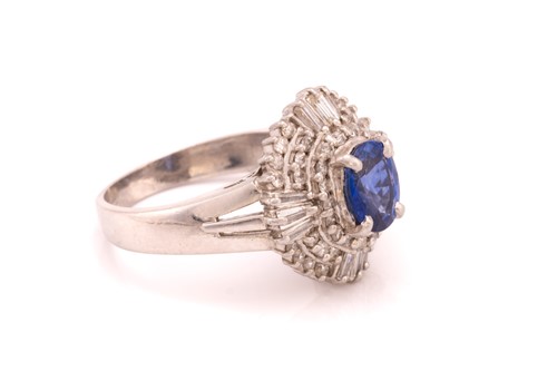 Lot 39 - A sapphire and diamond cluster ring, featuring...