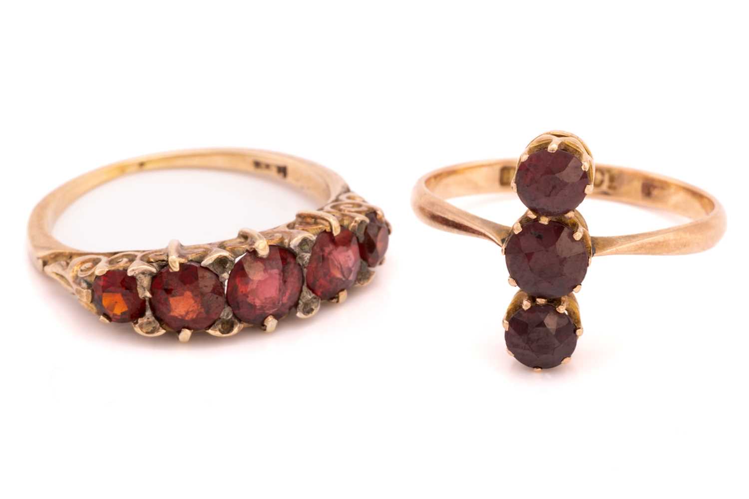 Lot 29 - Two garnet rings, the first consists of three