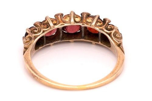 Lot 29 - Two garnet rings, the first consists of three...