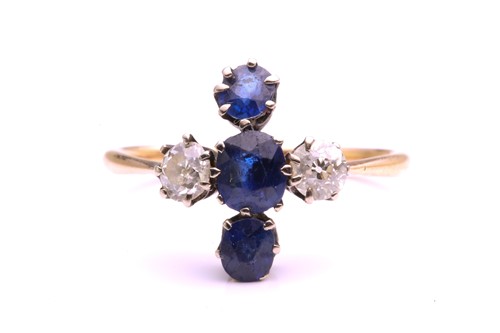 Lot 340 - A diamond and sapphire cross ring claw set...