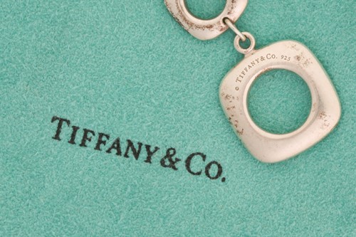 Lot 318 - Tiffany & Co. - a square cushion link bracelet,...