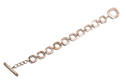 Lot 318 - Tiffany & Co. - a square cushion link bracelet,...