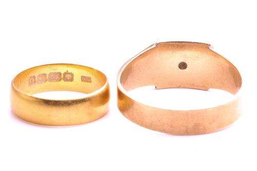 Lot 33 - A 22ct gold wedding band and a 9ct gold signet...