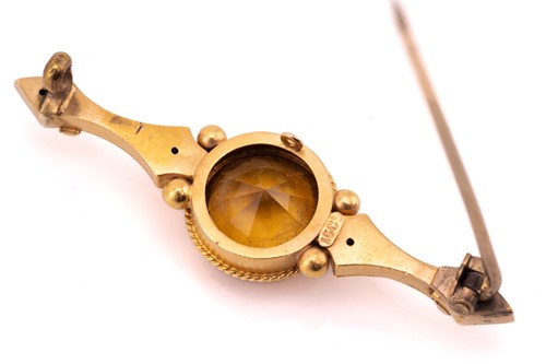 Lot 128 - A single stone citrine bar brooch, marked 15ct,...