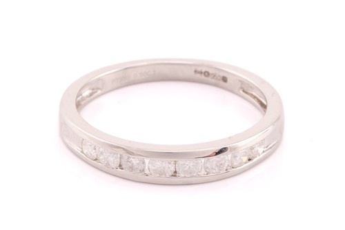 Lot 199 - A platinum and diamond half hoop eternity ring...