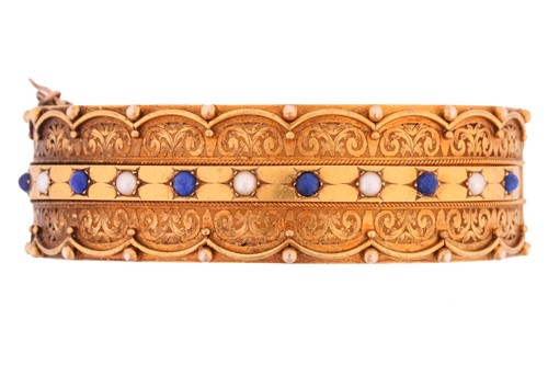 Lot 240 - A Victorian hinged bangle set with lapis...