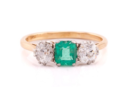 Lot 352 - An emerald and diamond trilogy ring, claw-set...