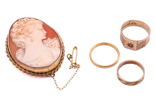 Lot 96 - A shell cameo brooch and three rings, the...