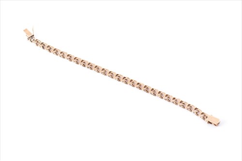 Lot 528 - A yellow metal flattened double-link bracelet...