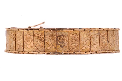 Lot 188 - A yellow metal panel link bracelet decorated...