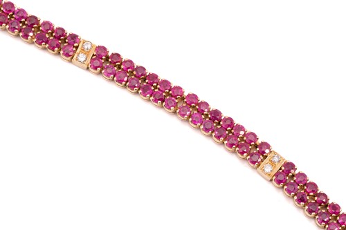 Lot 162 - A yellow metal, ruby and diamond line bracelet;...
