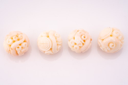 Lot 190 - Eight Chinese carved coral beads, the 21.2 mm...