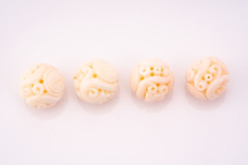 Lot 190 - Eight Chinese carved coral beads, the 21.2 mm...