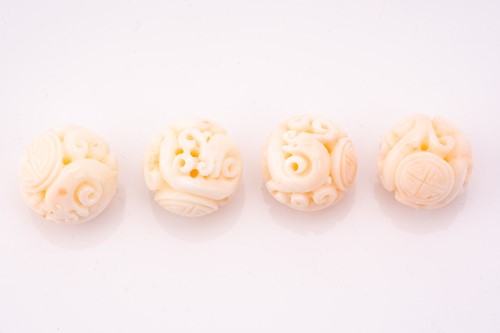 Lot 190 - Eight Chinese carved coral beads, the 21.2 mm...