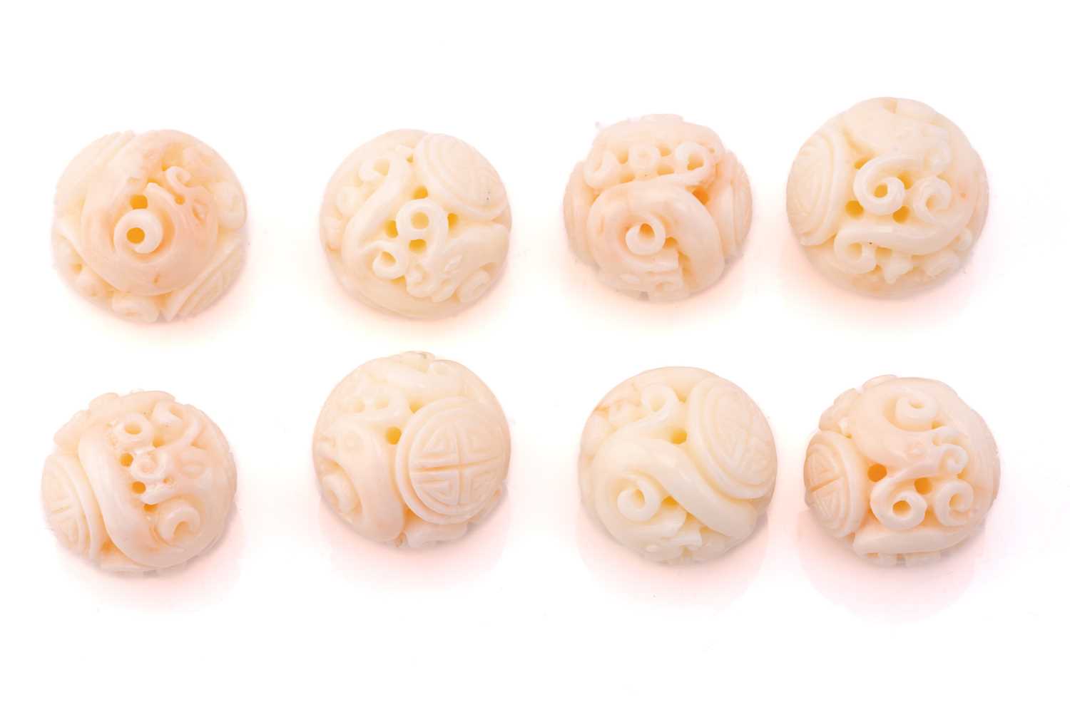Lot 190 - Eight Chinese carved coral beads, the 21.2 mm...