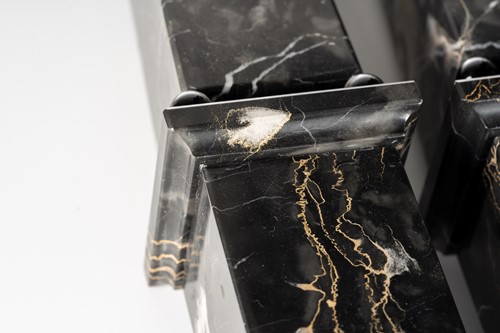 Lot 174 - A pair of variegated black marble obelisks, on...