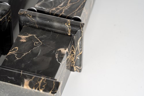 Lot 174 - A pair of variegated black marble obelisks, on...