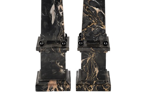 Lot 174 - A pair of variegated black marble obelisks, on...