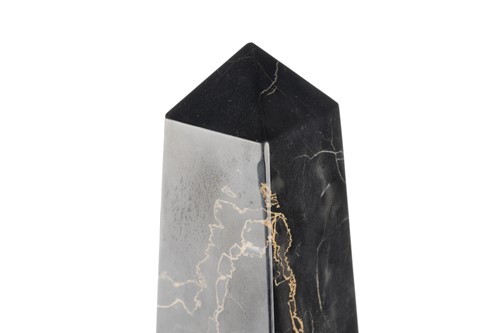 Lot 174 - A pair of variegated black marble obelisks, on...