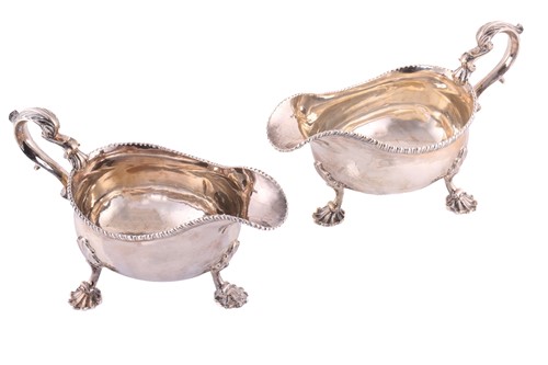 Lot 511 - A pair of George II silver sauce boats; with...