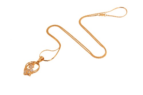 Lot 19 - A gem-set pendant on chain, of foliate design,...