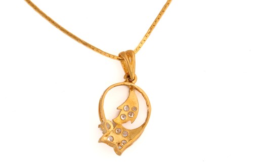 Lot 19 - A gem-set pendant on chain, of foliate design,...