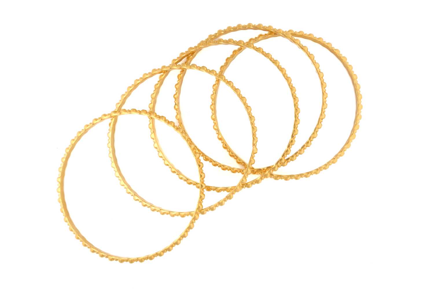 Lot 143 - A suite of five yellow metal bangles, of...