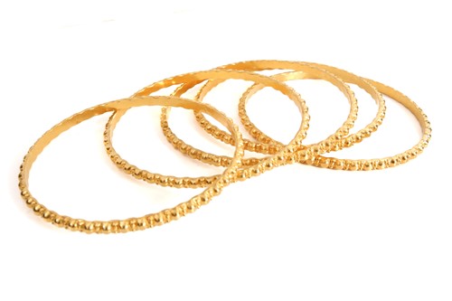 Lot 143 - A suite of five yellow metal bangles, of...