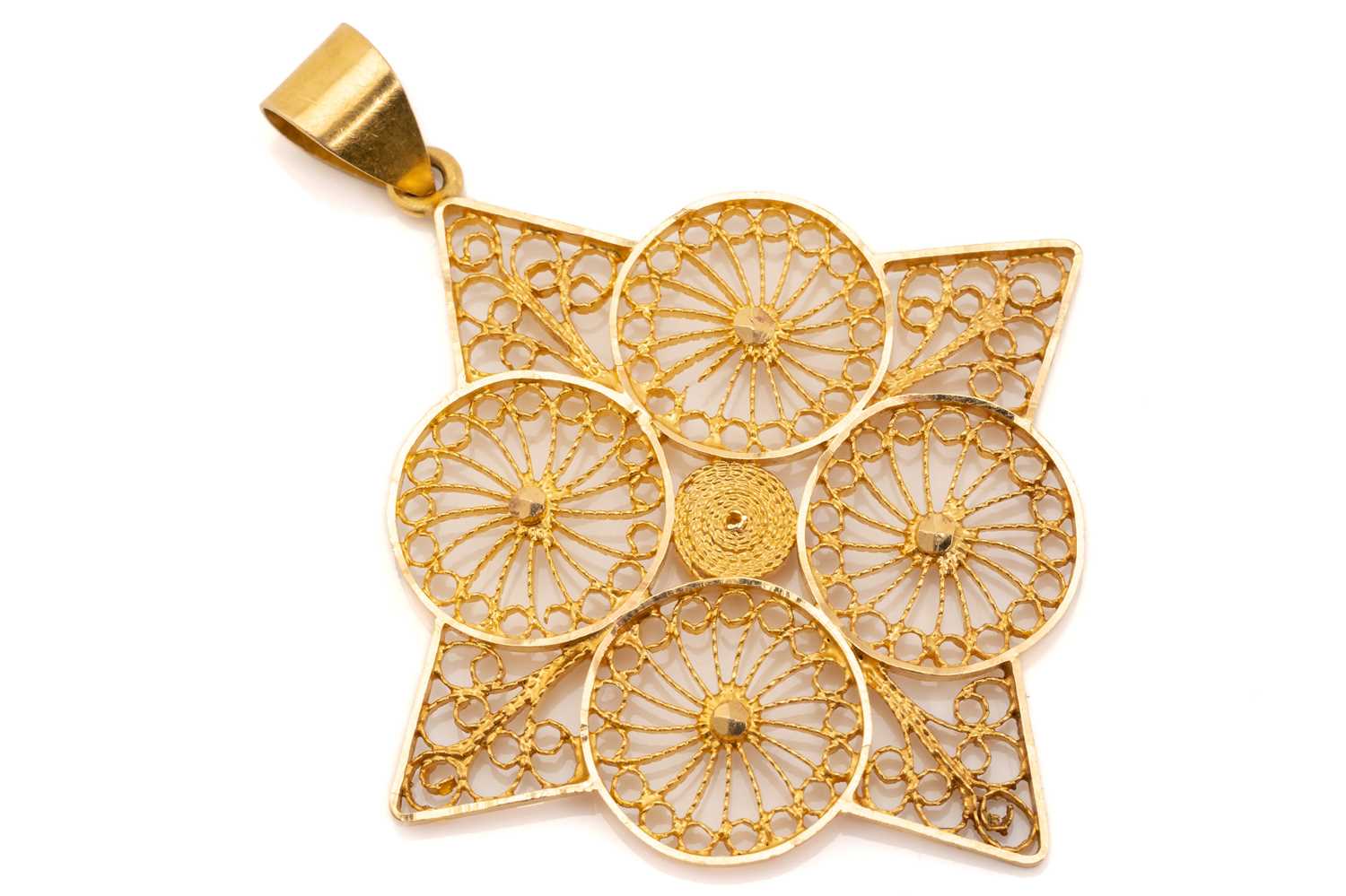 Lot 257 - A yellow metal filigree pendant, of geometric...