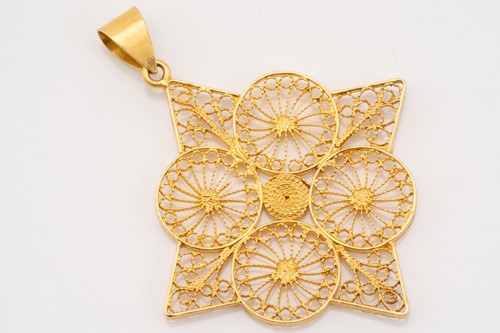 Lot 257 - A yellow metal filigree pendant, of geometric...