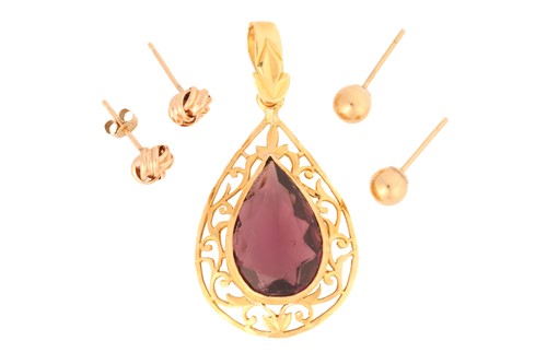 Lot 67 - A purple paste pendant with two pairs of stud...