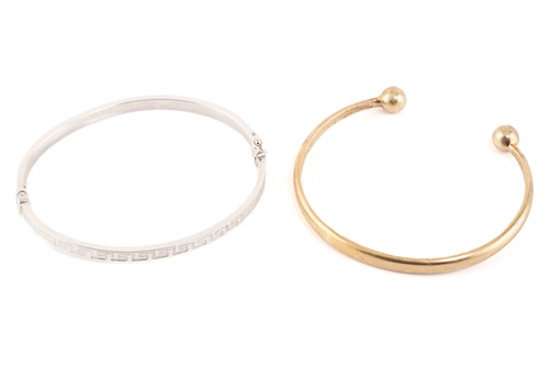 Lot 237 - Two bangles in 9ct gold; one torque bangle...